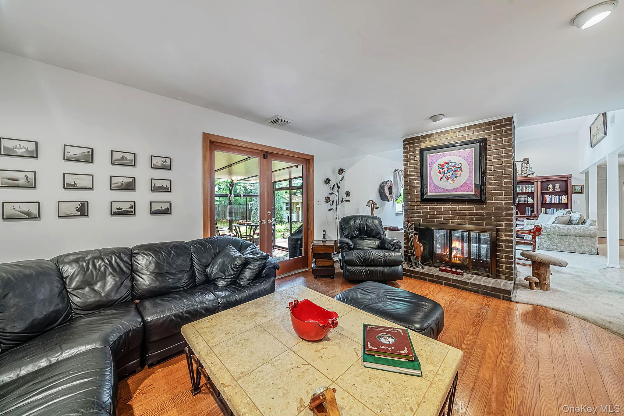 96 Fulton Boulevard Commack, NY 11725 - Photo 27 of 41 a living room with furniture and a flat screen tv