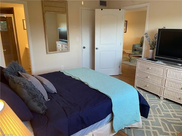 a bedroom with a bed and a television