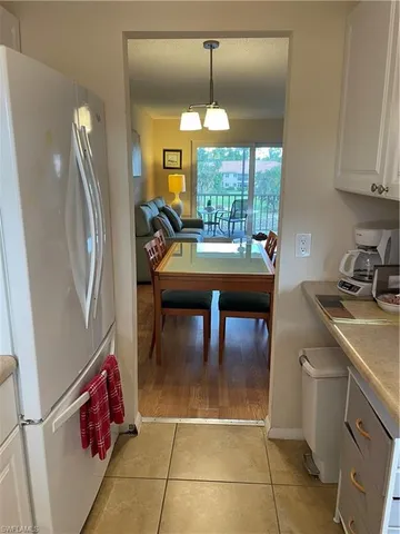 a view of a hallway with wooden floor and a workspace