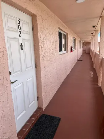 a view of a porch with chairs and backyard