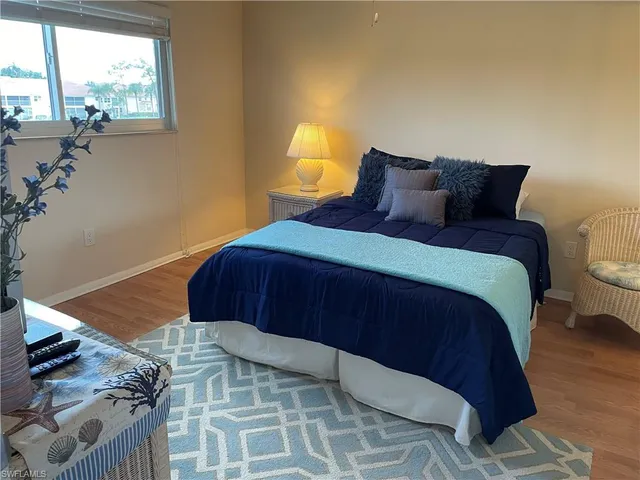 a bedroom with a bed and flat screen tv