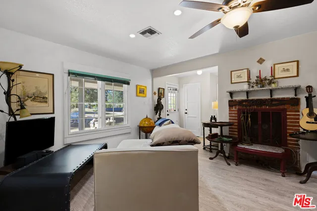 a kitchen with a stove a sink dishwasher a dining table and chairs with wooden floor