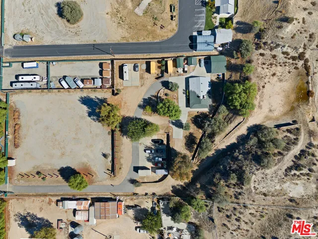 an aerial view of a house with a yard and lake view
