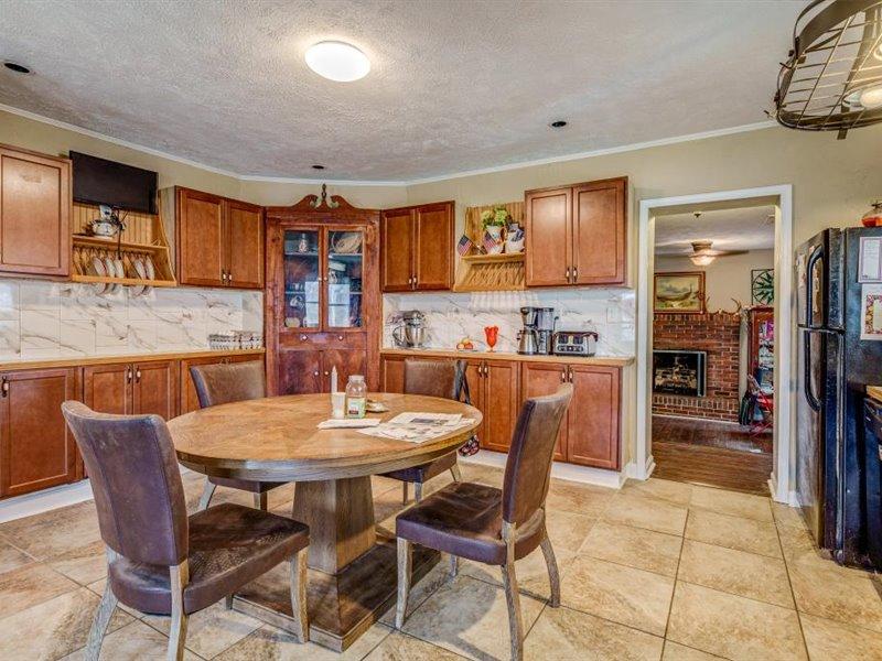 2331 Callaway Road Rocky Mount, VA 24151 - Photo 8 of 26 a dining area with stainless steel appliances kitchen island granite countertop a table chairs and a refrigerator