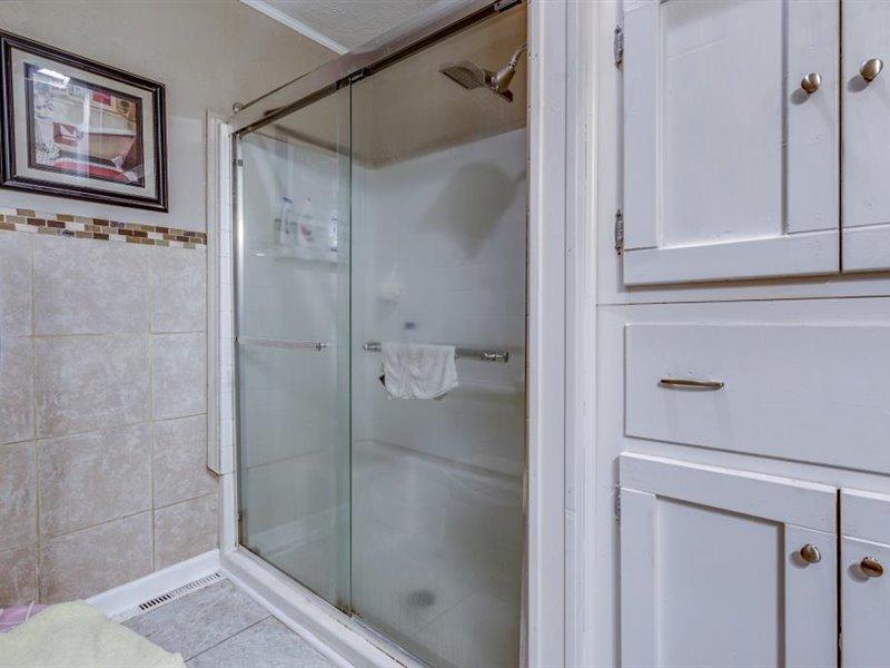 2331 Callaway Road Rocky Mount, VA 24151 - Photo 9 of 26 a bathroom with a glass shower door