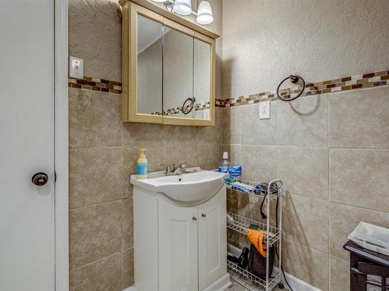 2331 Callaway Road Rocky Mount, VA 24151 - Photo 10 of 26 a bathroom with a sink and mirror with toilet