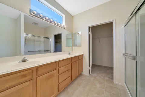 a spacious bathroom with a double vanity sink mirror and double