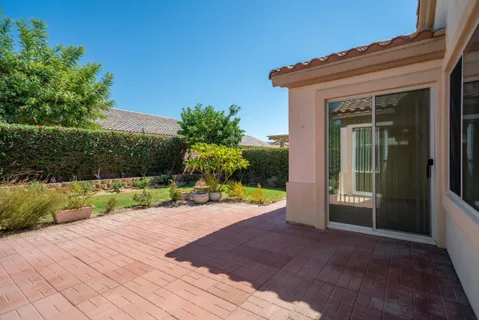 a view of backyard with plants and outdoor seating