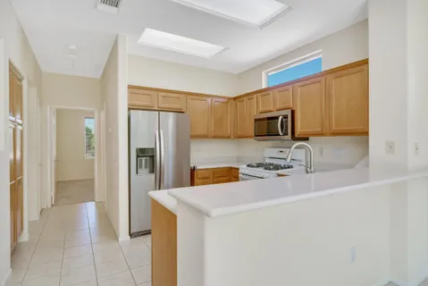 a kitchen with stainless steel appliances a refrigerator stove microwave and sink