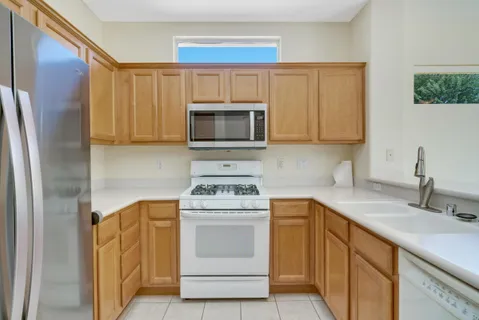 a kitchen with a sink stove and microwave