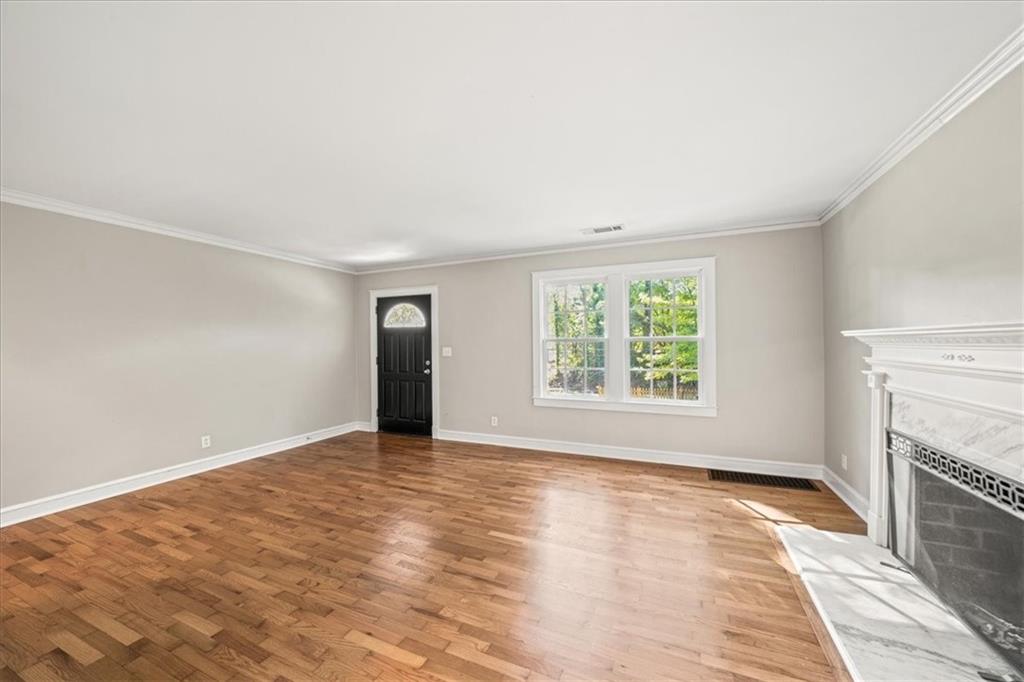 3494 Briarcliff Road Northeast Atlanta, GA 30345 - Photo 12 of 46 an empty room with windows and fireplace