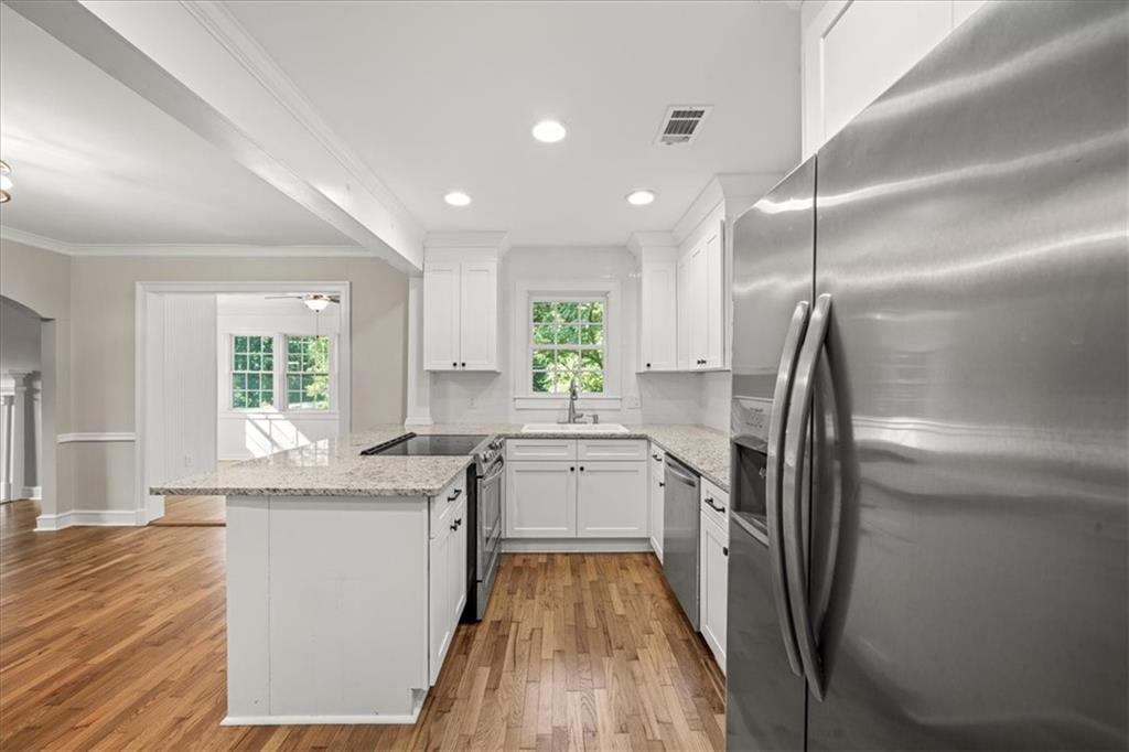 3494 Briarcliff Road Northeast Atlanta, GA 30345 - Photo 17 of 46 a kitchen with a sink appliances wooden floor and a window
