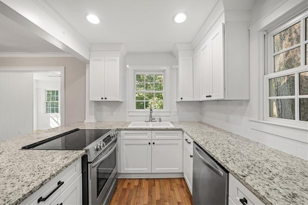 3494 Briarcliff Road Northeast Atlanta, GA 30345 - Photo 20 of 46 a kitchen with granite countertop a sink stove and cabinets