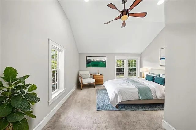 a bedroom with a bed furniture and a potted plant