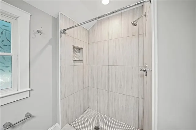 a bathroom with a shower and a sink