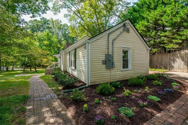 a view of a house with yard and a garden