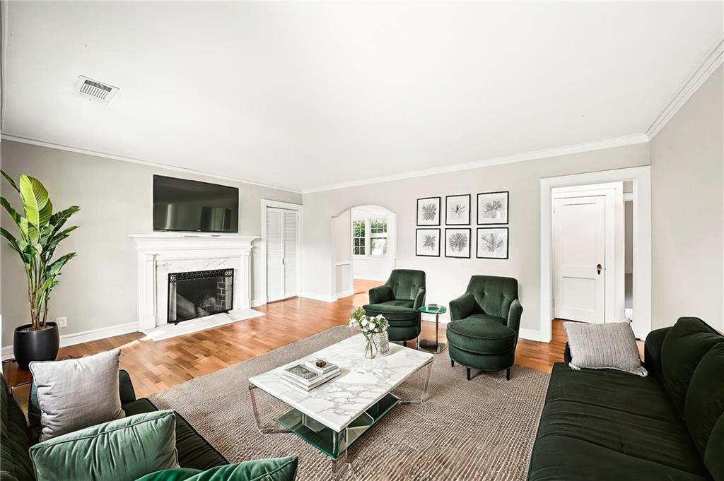 3494 Briarcliff Road Northeast Atlanta, GA 30345 - Photo 6 of 46 a living room with furniture a fireplace and a flat screen tv