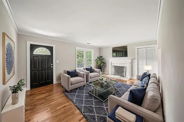 a living room with furniture a fireplace and a flat screen tv