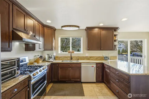 a kitchen with a sink stove and cabinets
