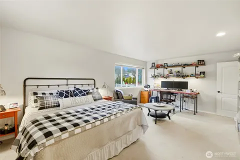 a bedroom with a bed a table and chair