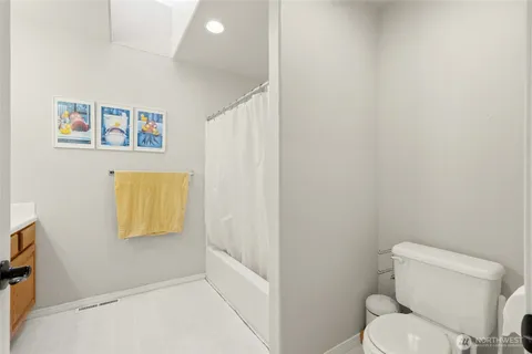 a white toilet sitting next to a bathroom sink