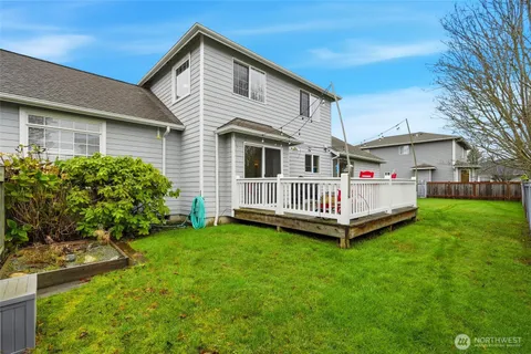 a view of a house with a yard and sitting area