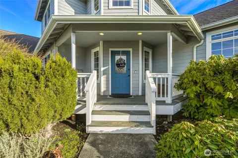 a front view of a house with a garden