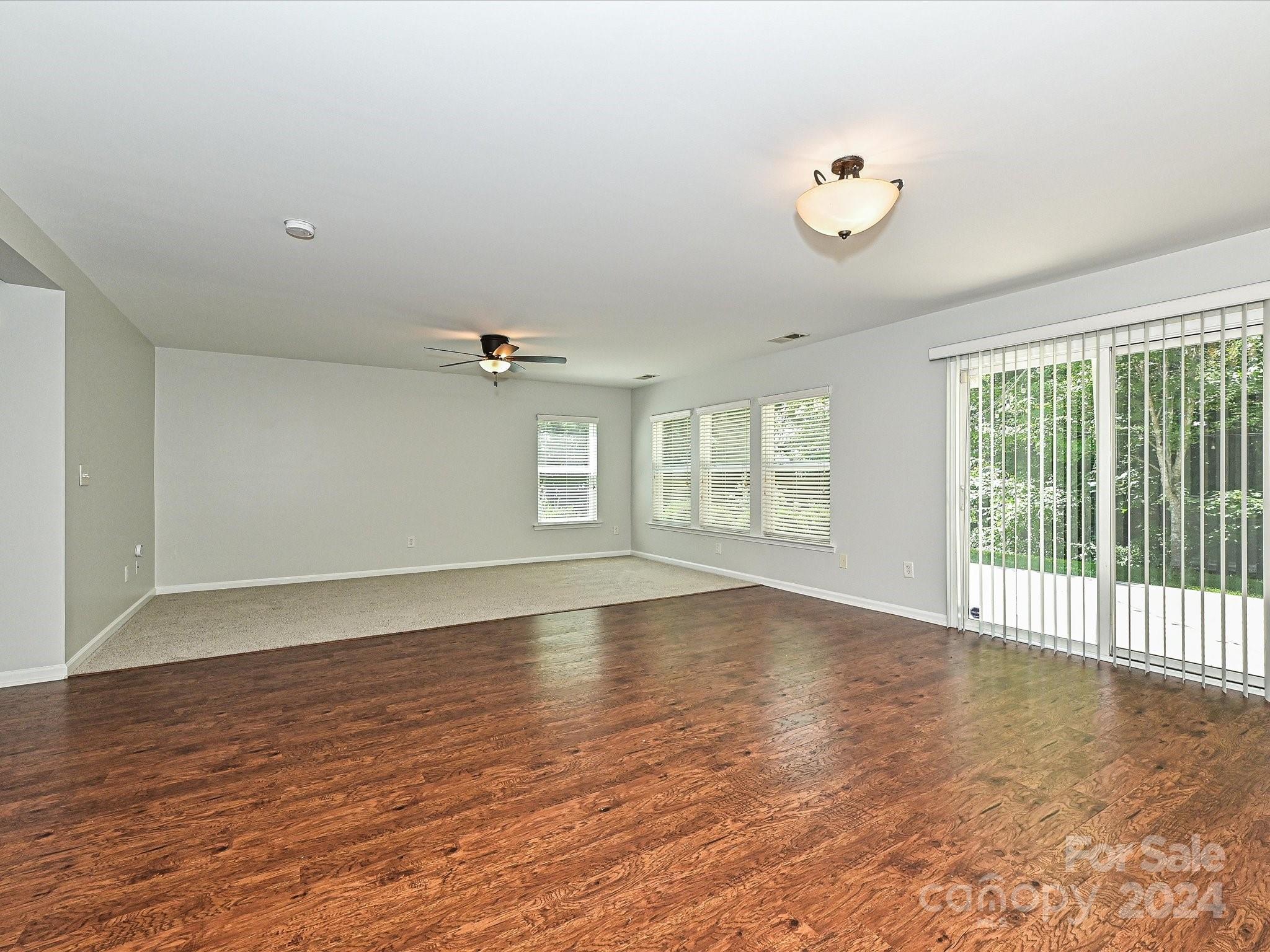796 Ivy Trail Way Fort Mill, SC 29715 - Photo 14 of 39 an empty room with wooden floor and windows