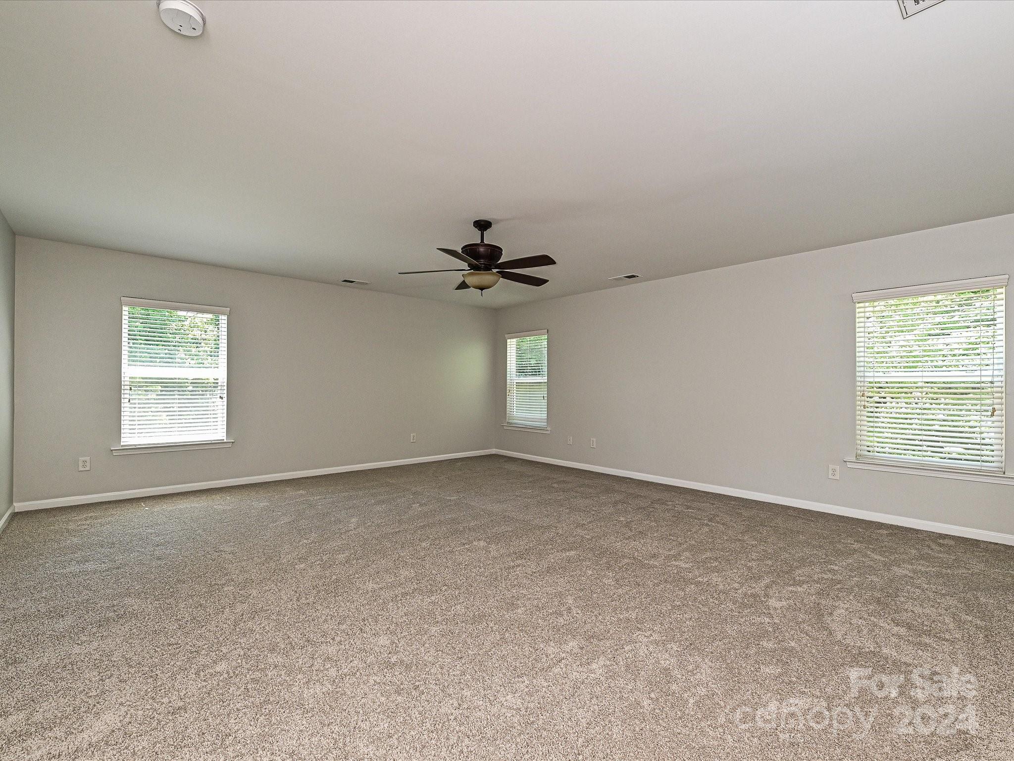 796 Ivy Trail Way Fort Mill, SC 29715 - Photo 23 of 39 an empty room with windows and fan