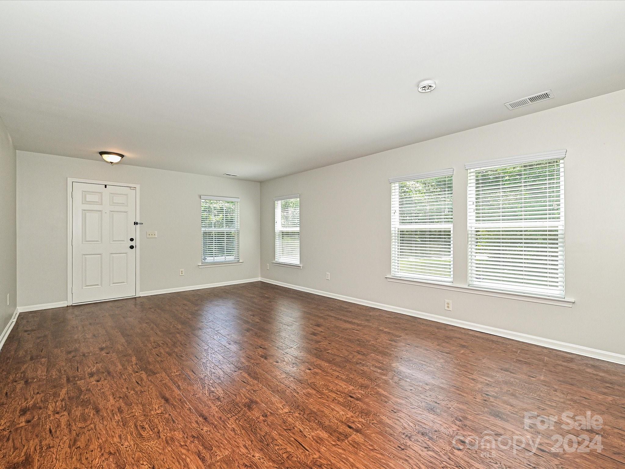 796 Ivy Trail Way Fort Mill, SC 29715 - Photo 5 of 39 an empty room with wooden floor and windows