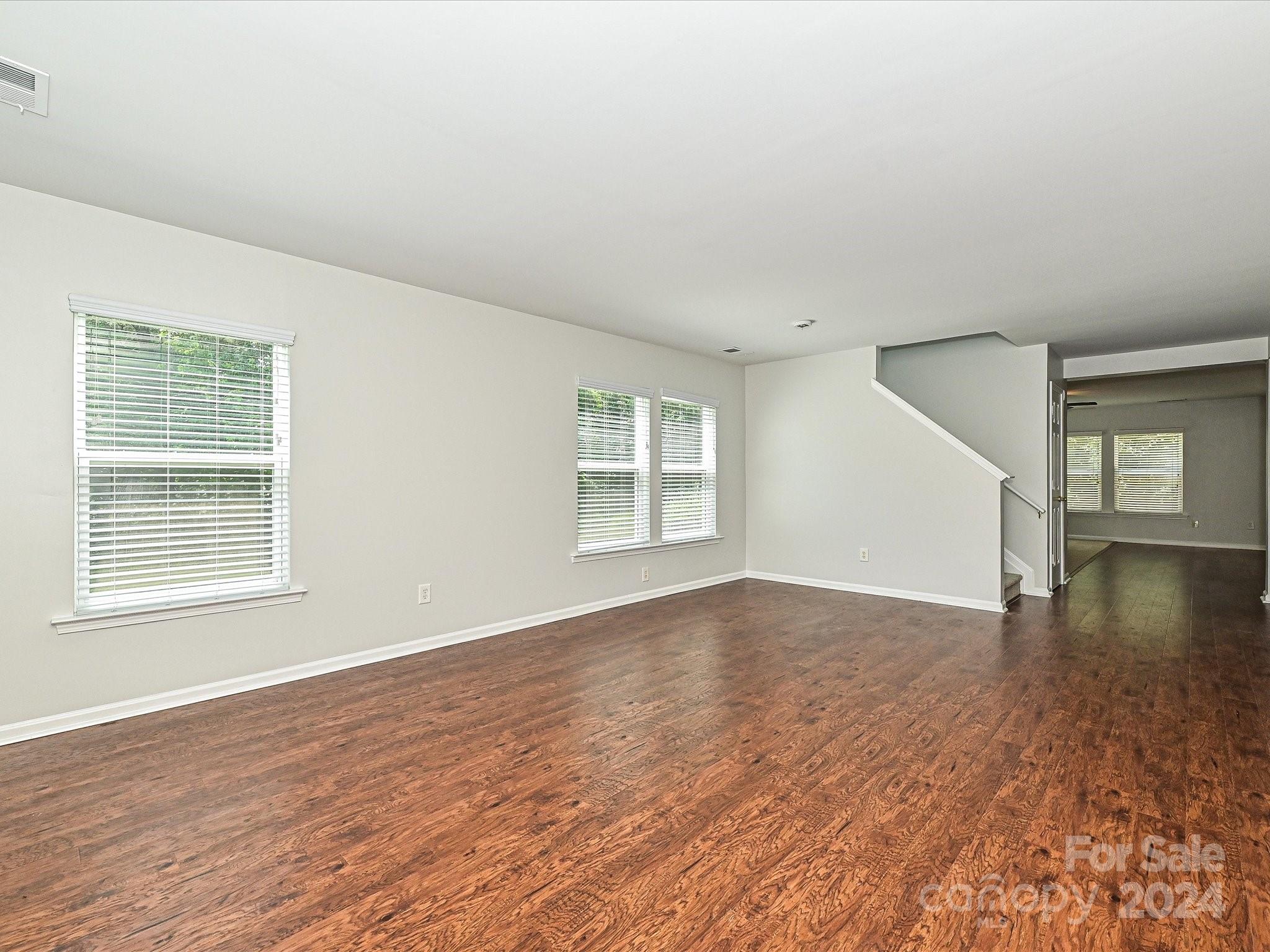 796 Ivy Trail Way Fort Mill, SC 29715 - Photo 7 of 39 a view of an empty room with window and wooden floor