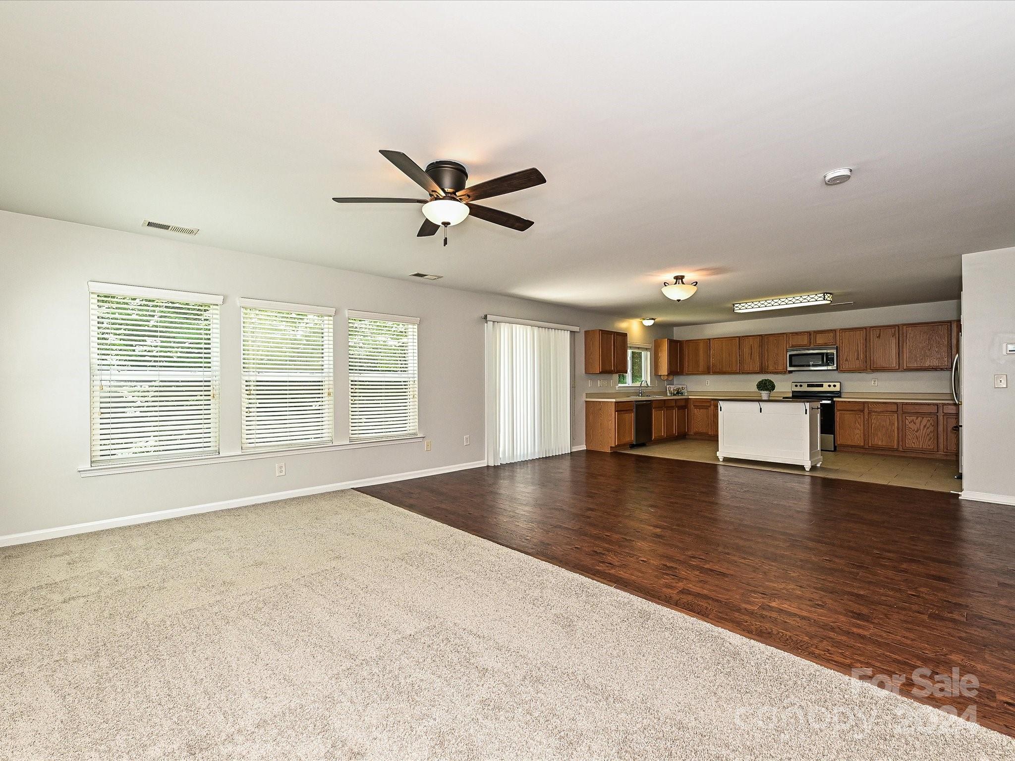 796 Ivy Trail Way Fort Mill, SC 29715 - Photo 9 of 39 a view of an empty room with a window and wooden floor