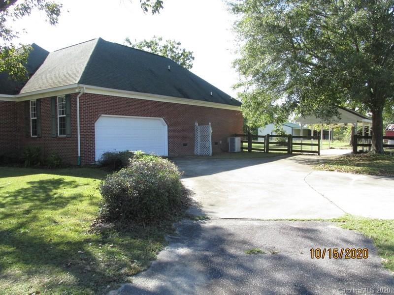 2227 Ridgeway Road Lugoff, SC 29078 - Photo 3 of 12 a front view of a house with a yard and garage