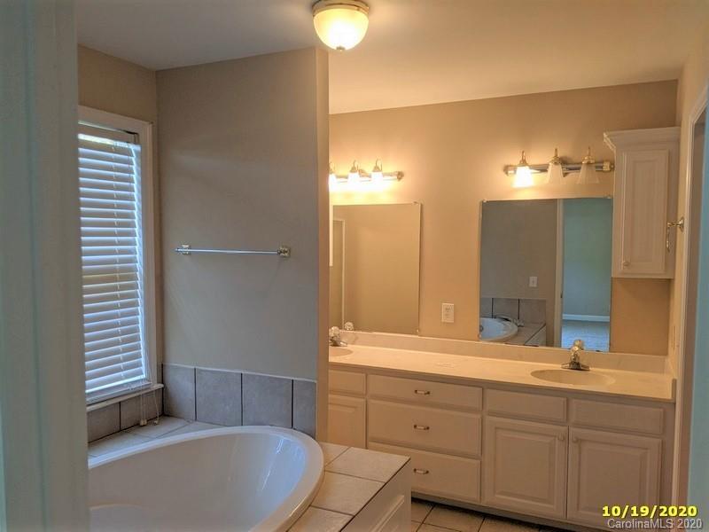 2227 Ridgeway Road Lugoff, SC 29078 - Photo 10 of 12 a bathroom with a tub sink and mirror