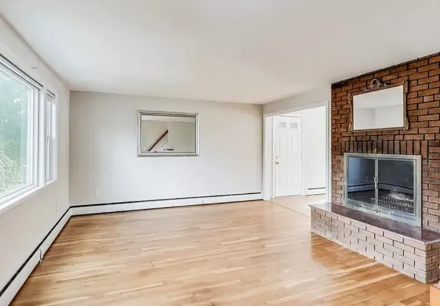 wooden floor in an empty room with a window