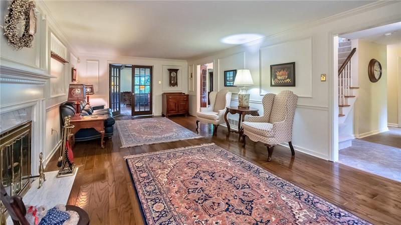 144 Berwyn Road Pittsburgh, PA 15237 - Photo 4 of 25 Spacious living room featuring hardwood floors, 1 of two fireplaces, and detailed trim.