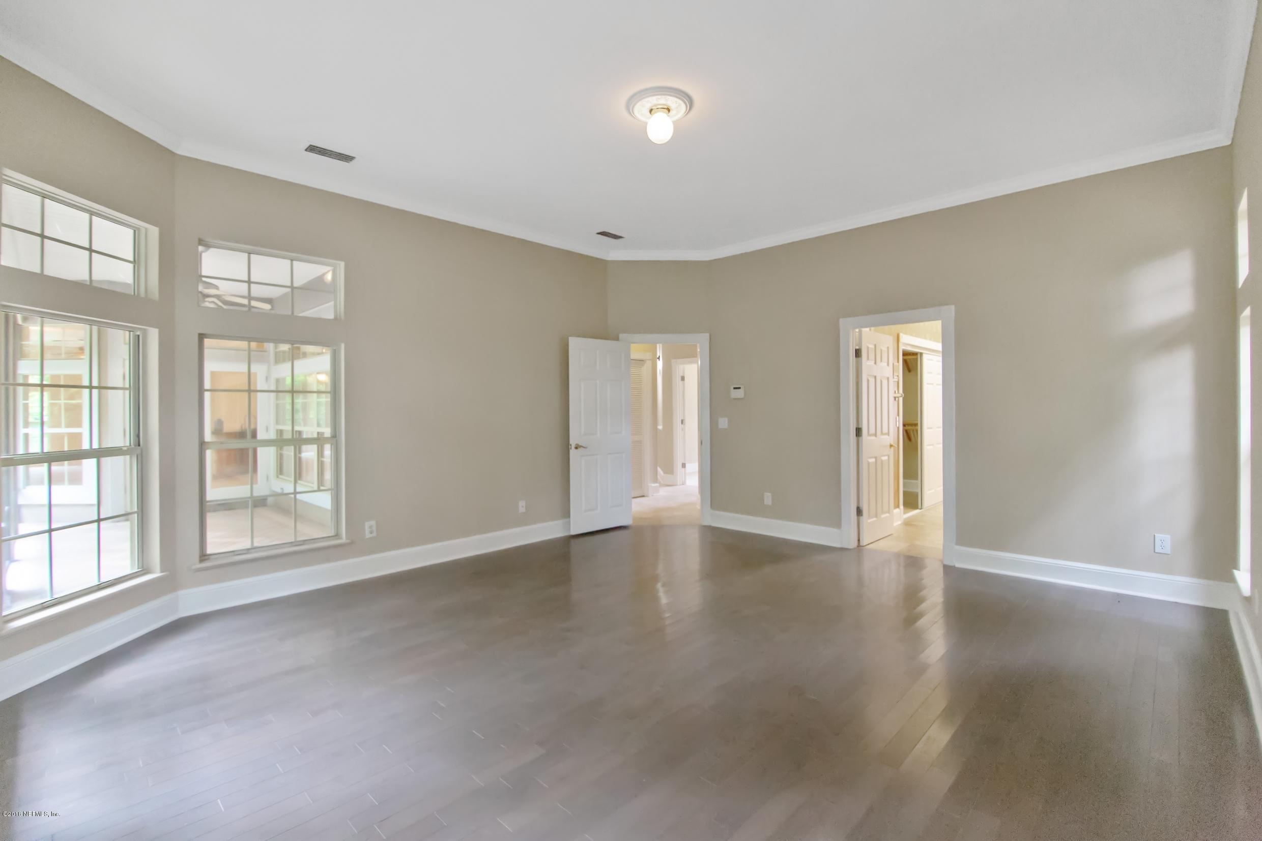 1899 Commodore Point Drive Orange Park, FL 32003 - Photo 13 of 52 a view of an empty room with a window and wooden floor