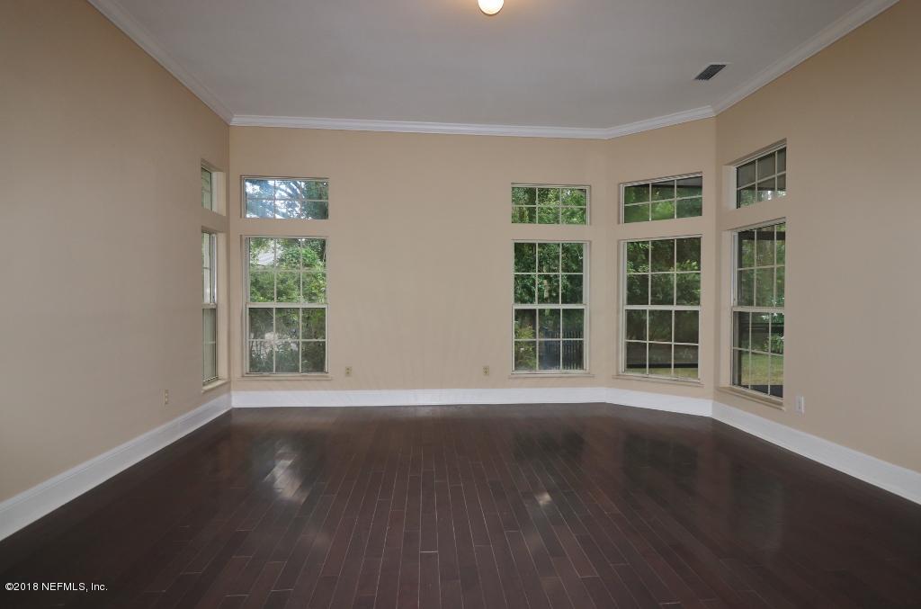 1899 Commodore Point Drive Orange Park, FL 32003 - Photo 22 of 52 a view of a big room with wooden floor and windows