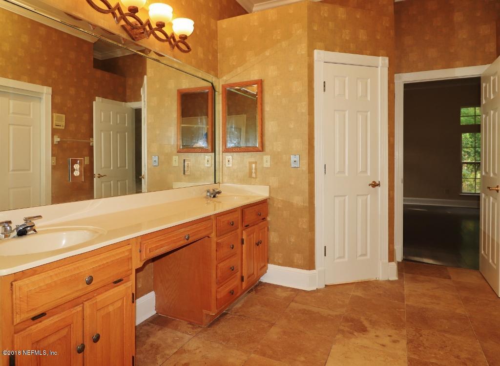 1899 Commodore Point Drive Orange Park, FL 32003 - Photo 25 of 52 a spacious bathroom with a double vanity sink a mirror and a shower