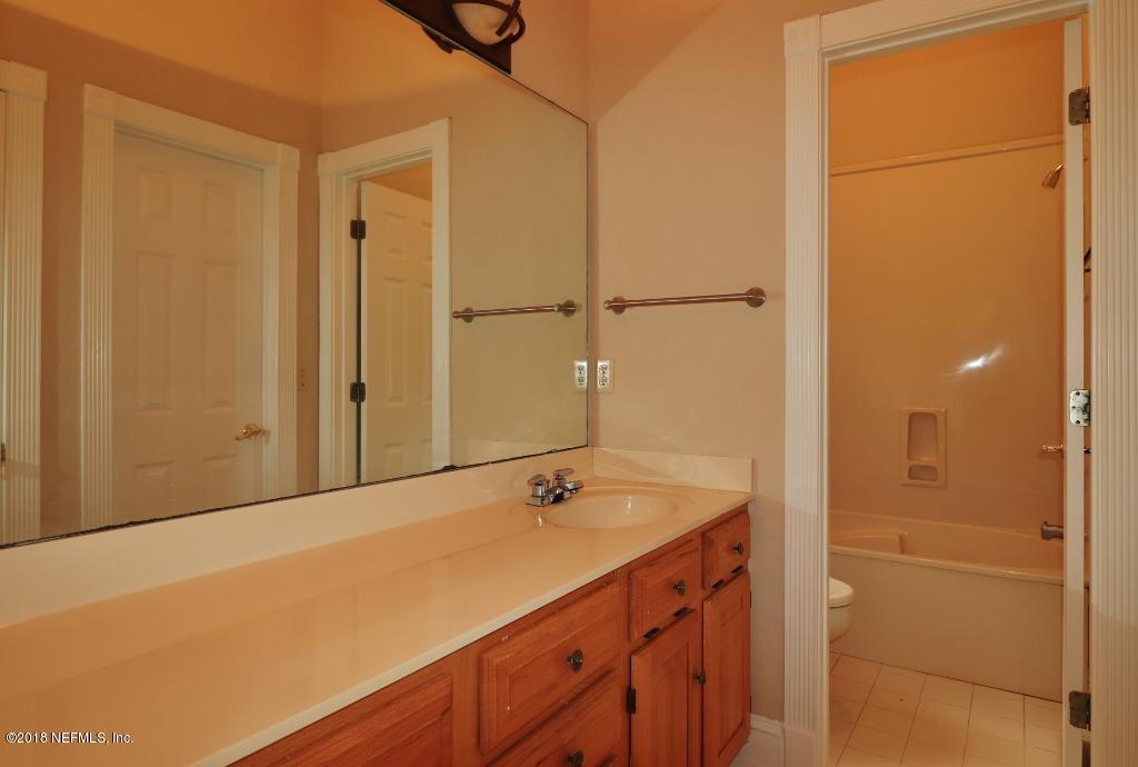 1899 Commodore Point Drive Orange Park, FL 32003 - Photo 30 of 52 a bathroom with a sink and a mirror