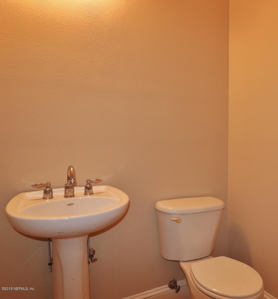 1899 Commodore Point Drive Orange Park, FL 32003 - Photo 31 of 52 a bathroom with a toilet a sink and mirror