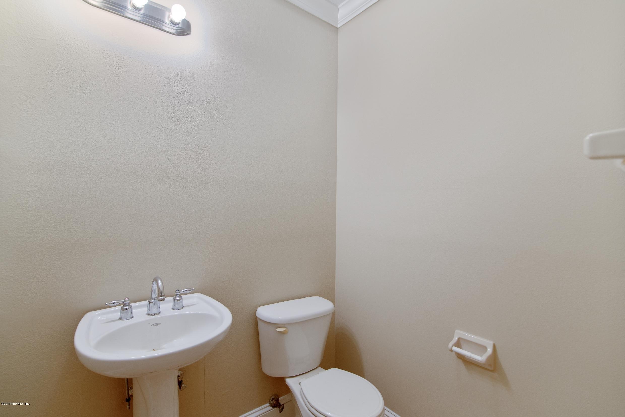 1899 Commodore Point Drive Orange Park, FL 32003 - Photo 40 of 52 a bathroom with a sink mirror and toilet