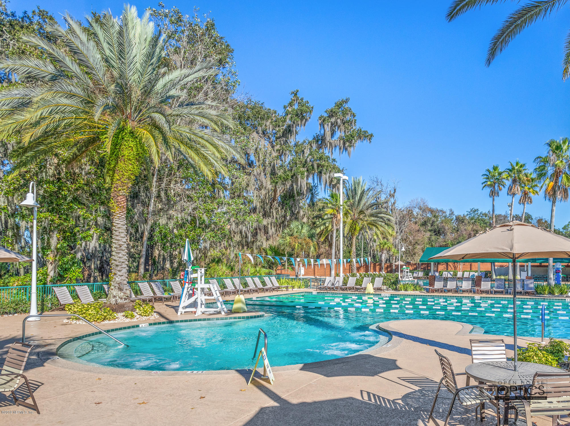 1899 Commodore Point Drive Orange Park, FL 32003 - Photo 47 of 52 a view of a swimming pool with lawn chairs under an umbrella