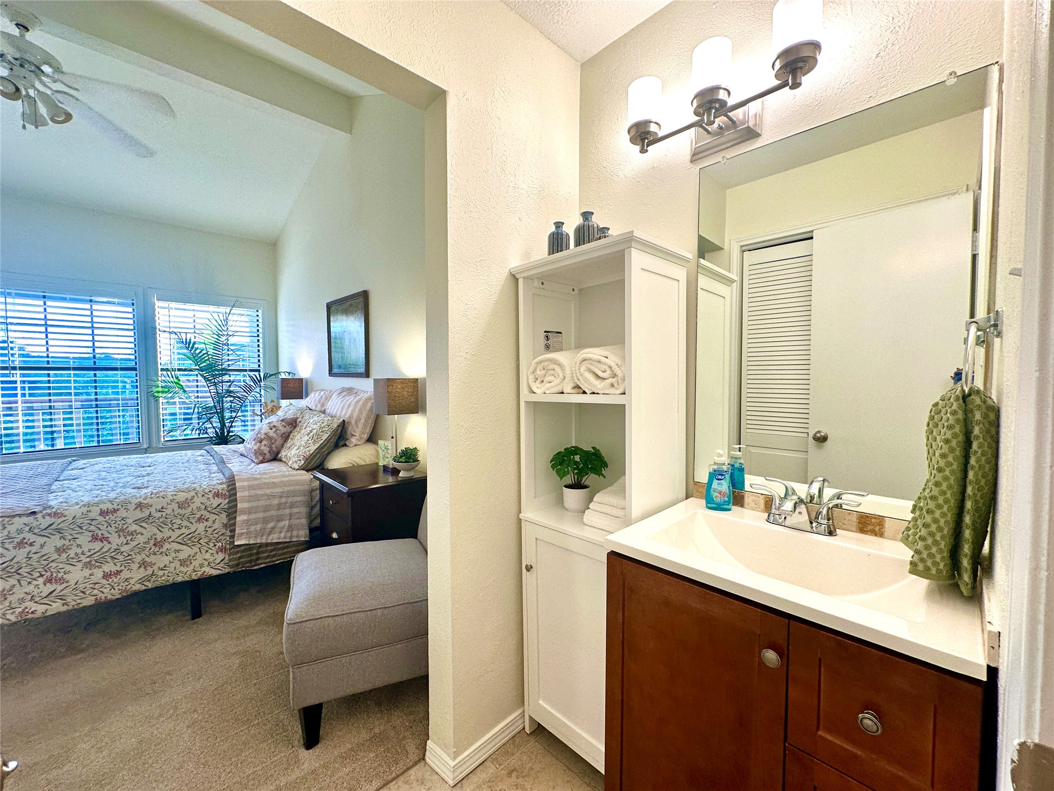 2215 Post Road, Unit 2055 Austin, TX 78704 - Photo 14 of 30 A compact vanity setup connects smoothly to the primary bedroom and the full bath adjacent.