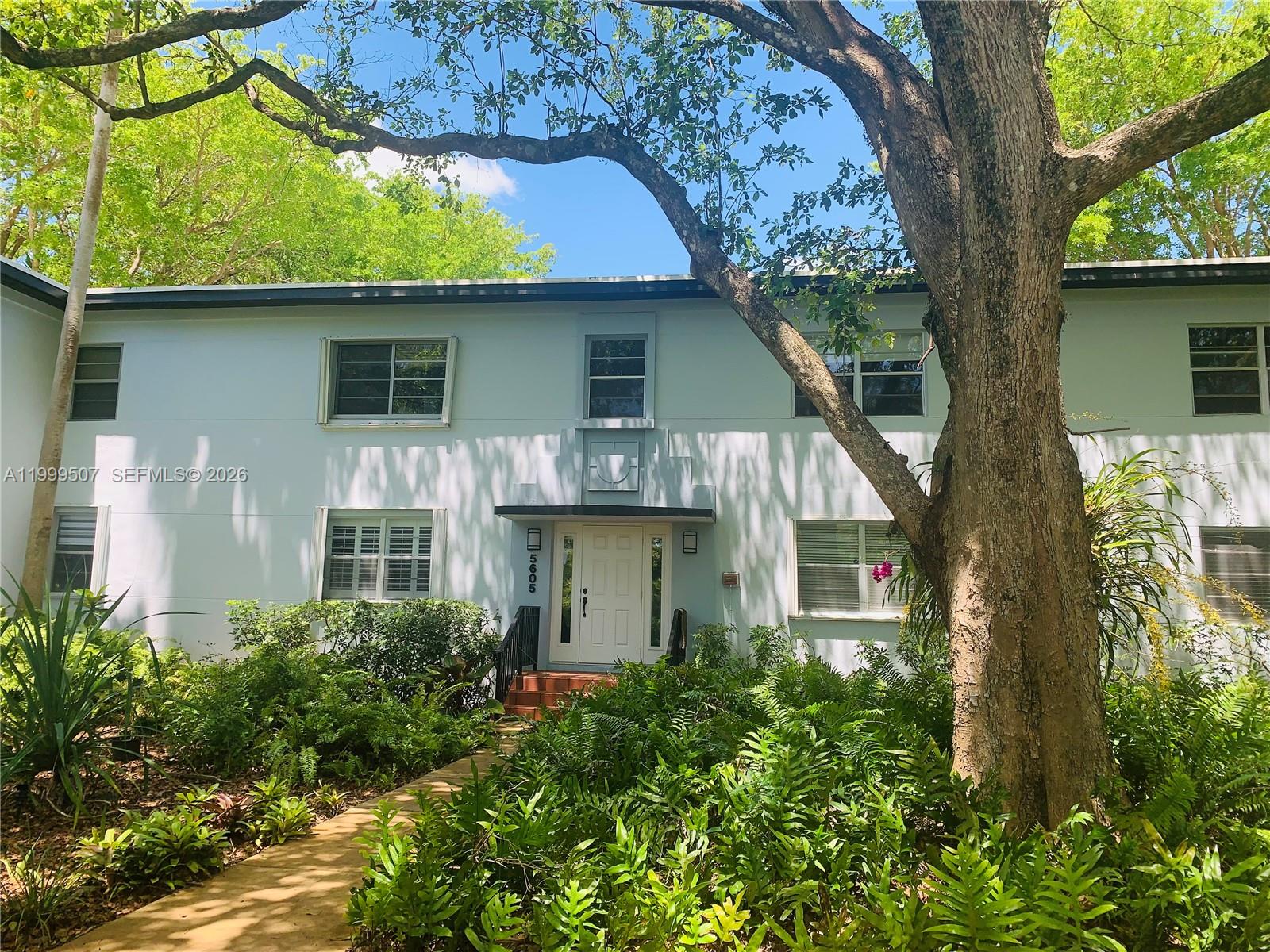 5605 Southwest 80th Street, Unit 97A Miami, FL 33143 - Photo 1 of 25 a front view of a house with a garden