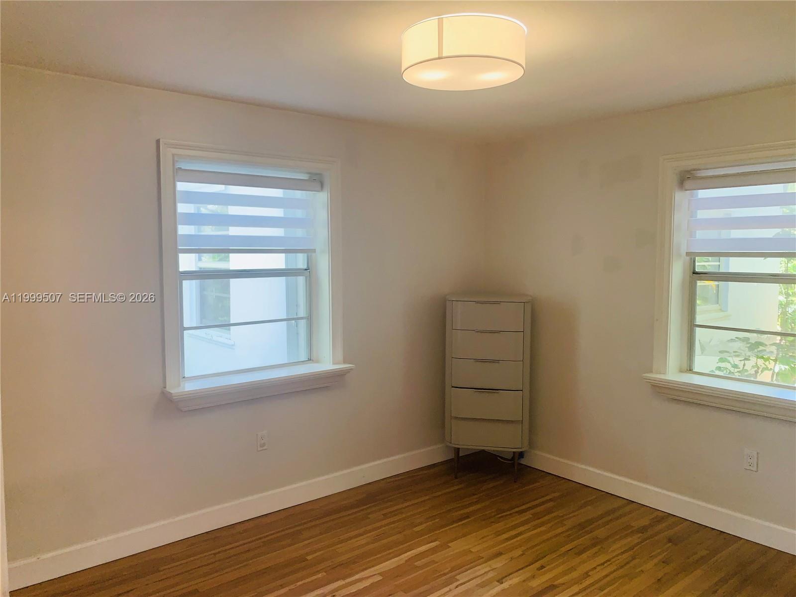5605 Southwest 80th Street, Unit 97A Miami, FL 33143 - Photo 12 of 25 an empty room with wooden closet and windows