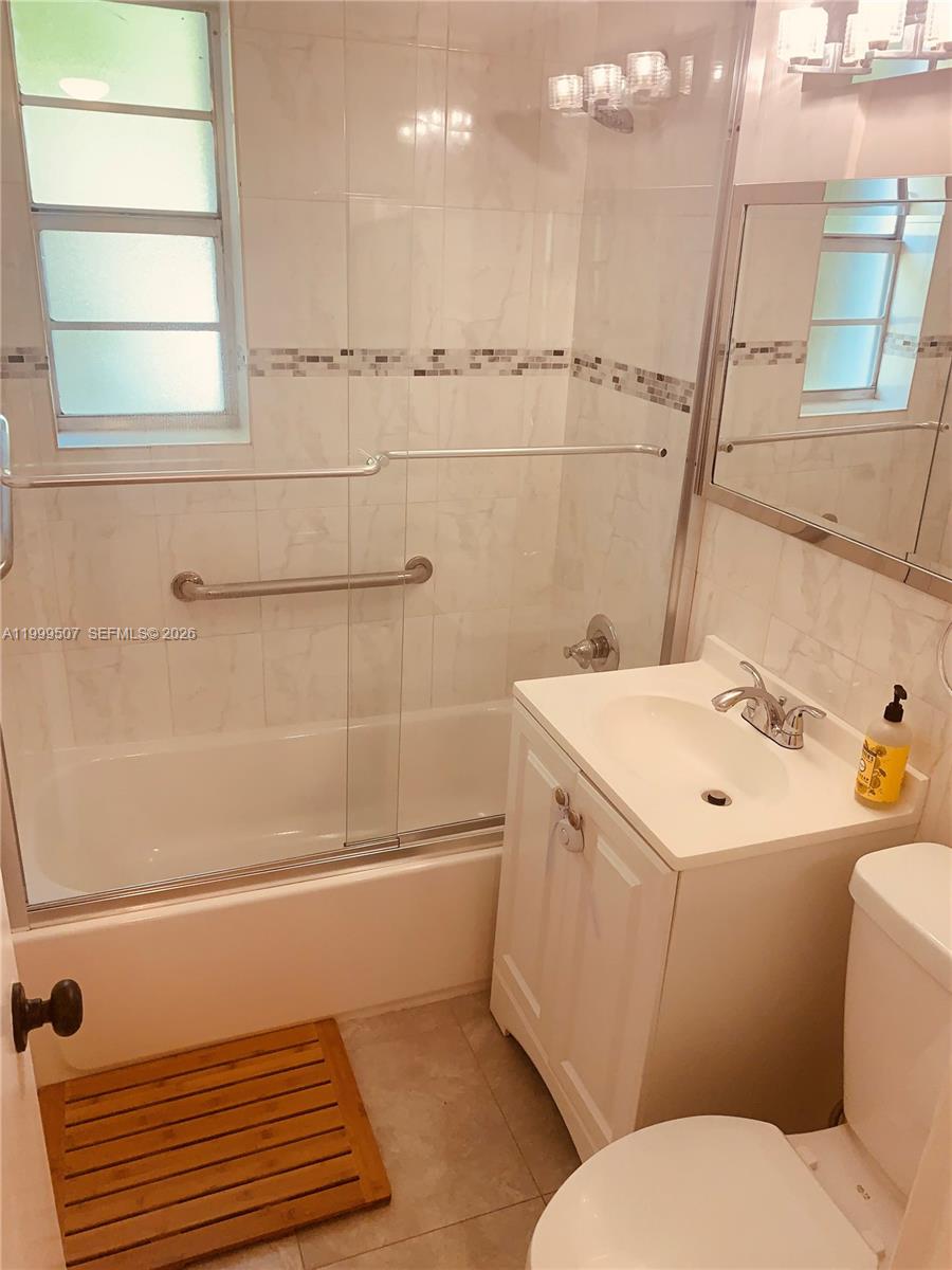 5605 Southwest 80th Street, Unit 97A Miami, FL 33143 - Photo 14 of 25 a bathroom with a sink a toilet and shower
