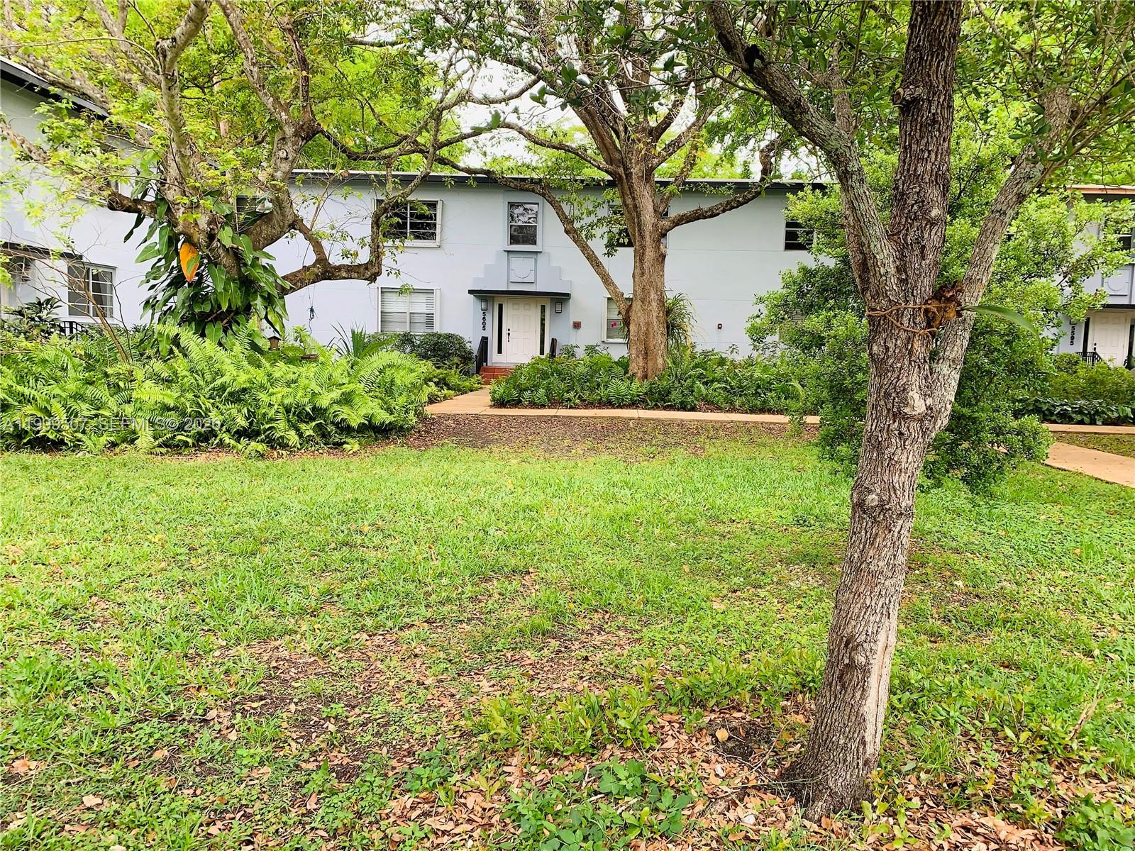 5605 Southwest 80th Street, Unit 97A Miami, FL 33143 - Photo 2 of 25 a front view of a house with a yard