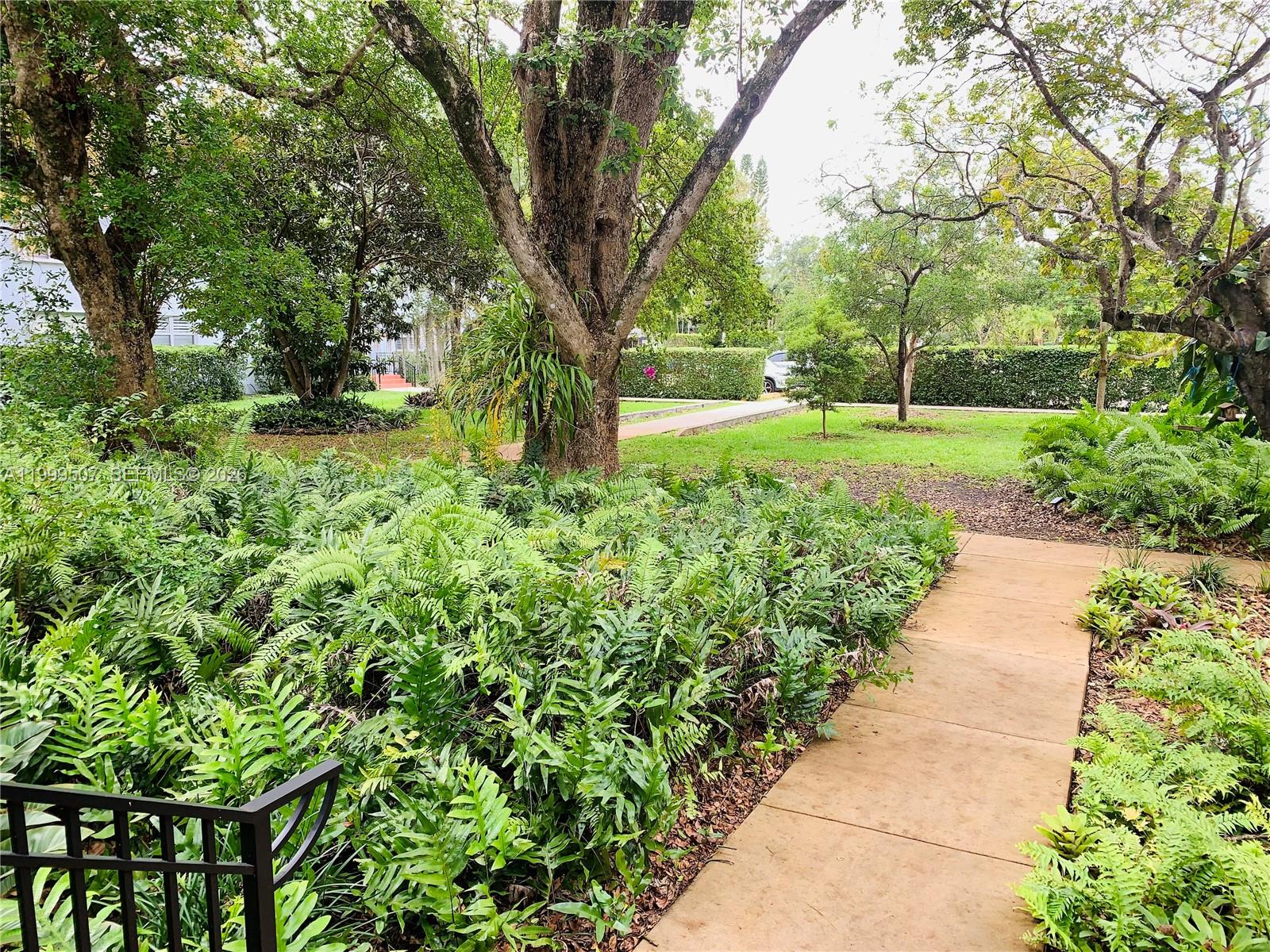 5605 Southwest 80th Street, Unit 97A Miami, FL 33143 - Photo 4 of 25 a view of a yard with plants and trees