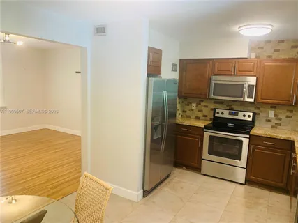 a kitchen with a refrigerator stove and microwave